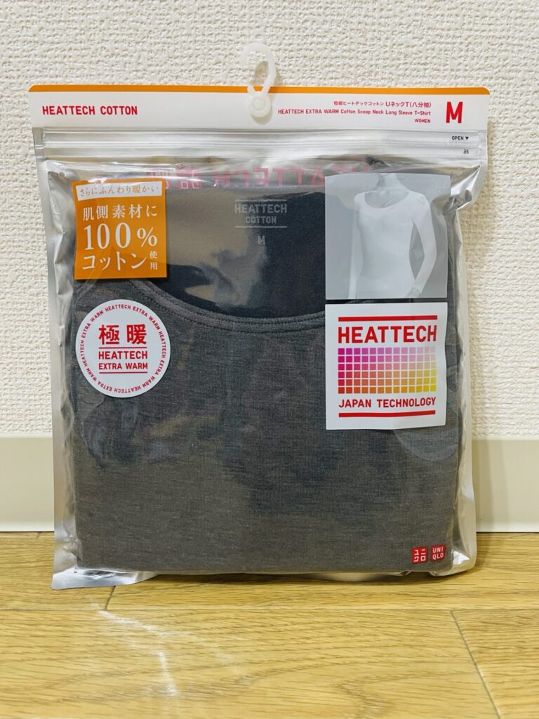 ユニクロの極暖ヒートテックコットン（肌側素材100％コットン）のパッケージ写真。グレーの長袖インナーで、日本製技術「HEATTECH EXTRA WARM」と記載されている。